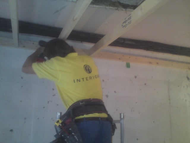 CPH Interiors joiner fitting timber battens to a ceiling