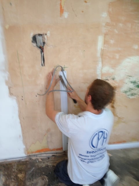 CPH Interiors electrician running cable in a wall channel
